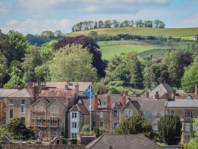 Picturesque townhouses in Burton, England, surrounded by lush greenery.